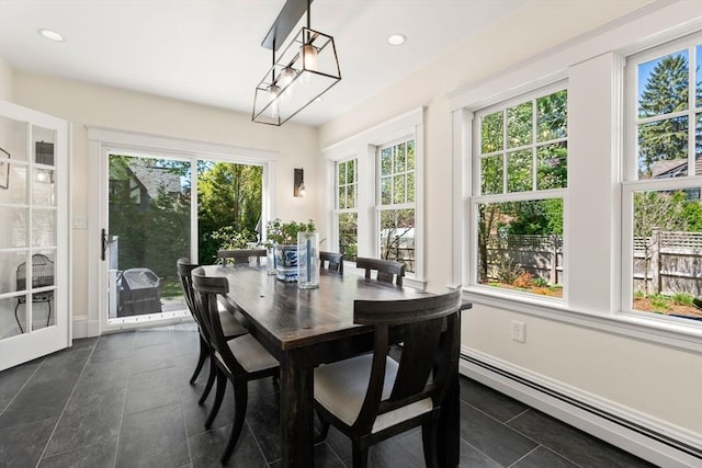 sunroom / solarium with tile patterned floors, a baseboard radiator, baseboards, and recessed lighting