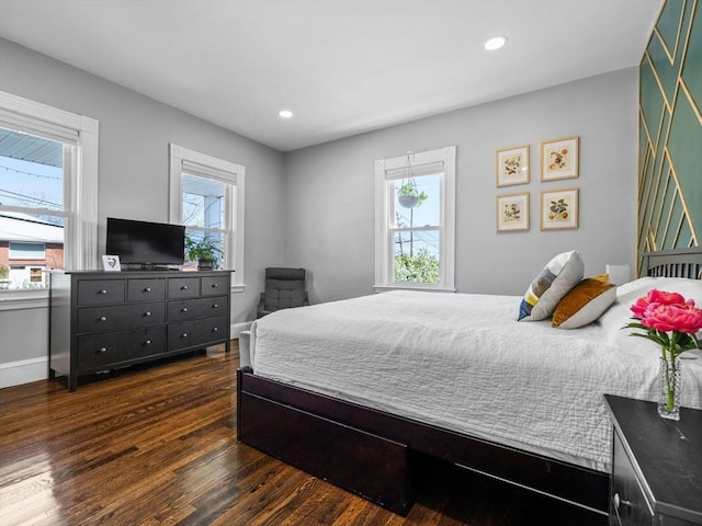 bedroom with recessed lighting, dark wood finished floors, and multiple windows