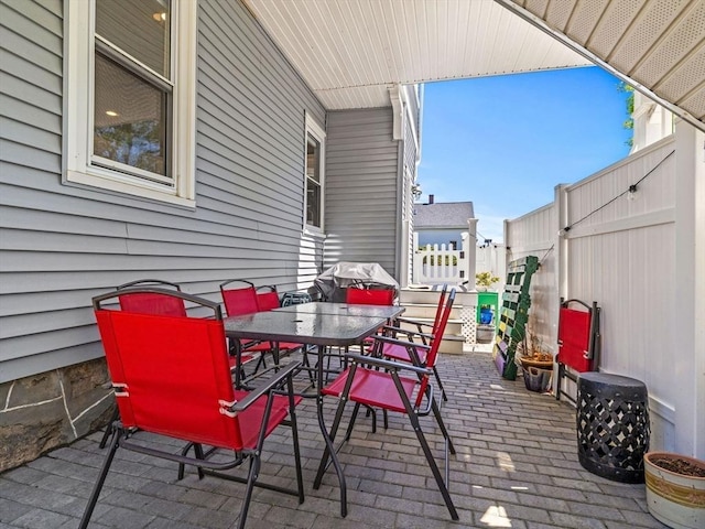 view of patio / terrace featuring fence and outdoor dining space
