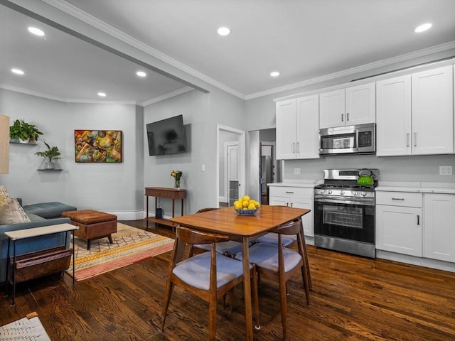 kitchen with light countertops, ornamental molding, stainless steel appliances, recessed lighting, and dark wood-style floors