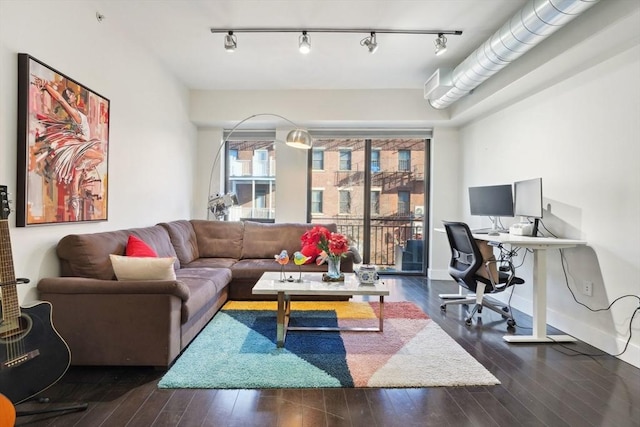 living room featuring dark wood-type flooring and track lighting