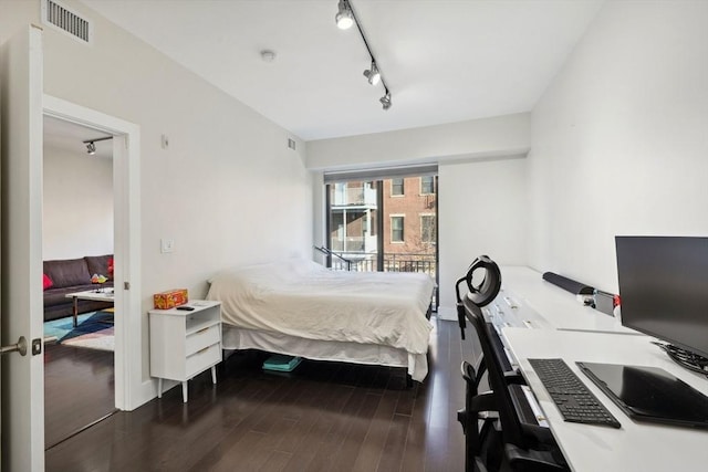 bedroom with dark hardwood / wood-style flooring