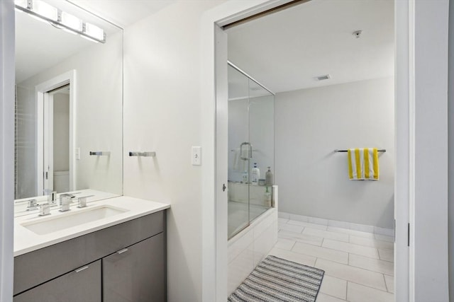 bathroom featuring shower / bath combination with glass door, vanity, and tile patterned floors