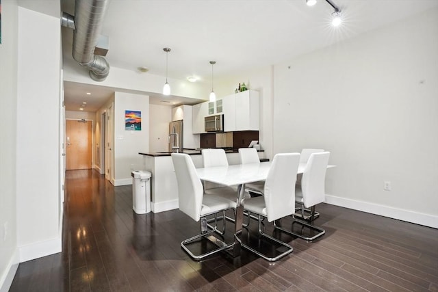 dining area with dark wood-type flooring