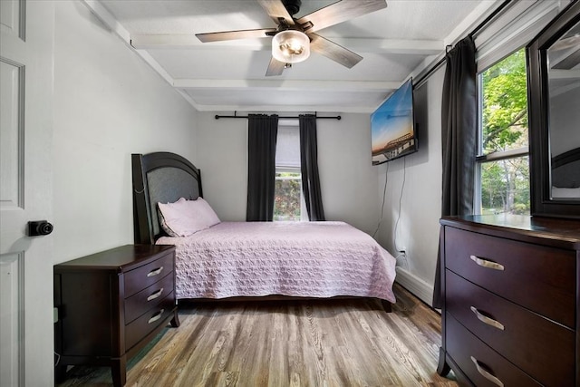 bedroom with wood finished floors, a ceiling fan, and baseboards
