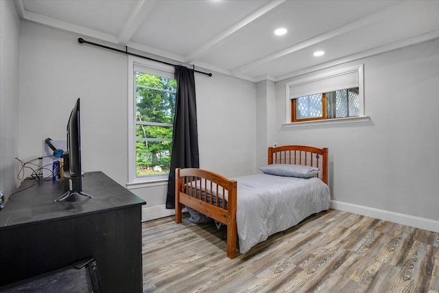 bedroom with light wood-type flooring, beamed ceiling, baseboards, and recessed lighting