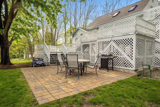 view of patio / terrace with stairs, a deck, a grill, and outdoor dining area