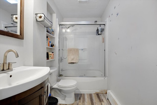 bathroom with wood finished floors, toilet, vanity, and combined bath / shower with glass door