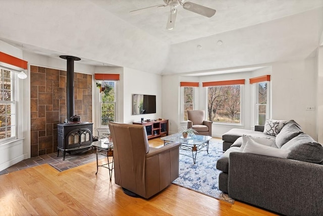 10 Deer Run Dr, Westford, MA 01886 - living area featuring ceiling fan, a wood stove, wood finished floors, and a wealth of natural light