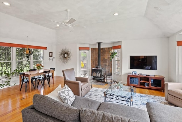 10 Deer Run Dr, Westford, MA 01886 - living area with vaulted ceiling, a healthy amount of sunlight, a wood stove, and wood finished floors