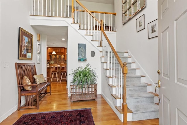 10 Deer Run Dr, Westford, MA 01886 - staircase with recessed lighting, baseboards, wood finished floors, and a towering ceiling