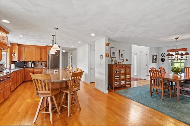 10 Deer Run Dr, Westford, MA 01886 - dining area featuring light wood-type flooring, recessed lighting, a notable chandelier, and a wealth of natural light