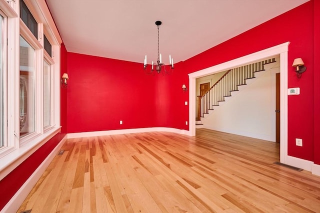 interior space with hardwood / wood-style floors and a notable chandelier