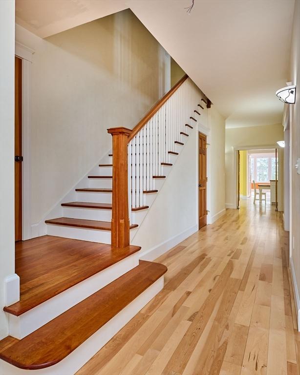 stairs with hardwood / wood-style flooring