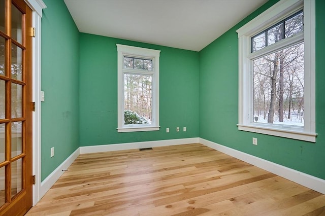 spare room with light hardwood / wood-style flooring