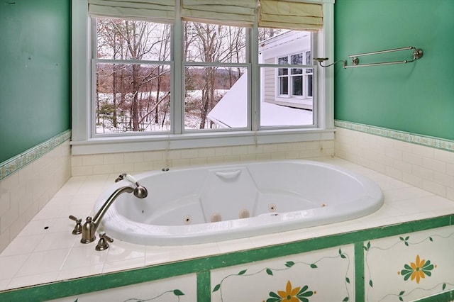 bathroom with a healthy amount of sunlight and tiled tub