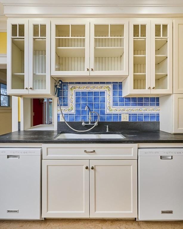 kitchen featuring white dishwasher, sink, and decorative backsplash