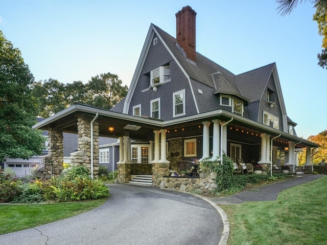 exterior space with a porch and a lawn