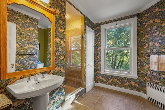 bathroom with tile patterned floors, crown molding, radiator heating unit, and a shower with shower door