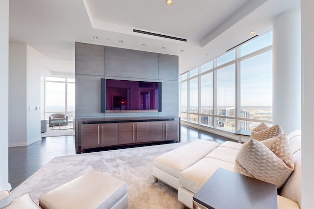 living room featuring a wall of windows and light hardwood / wood-style flooring