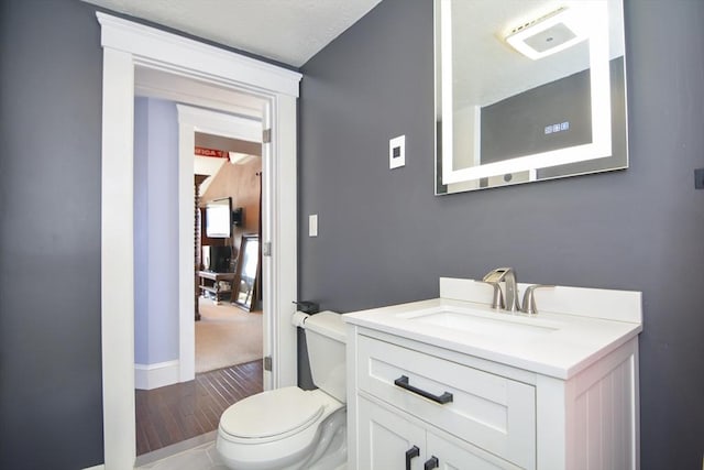 half bathroom with toilet and vanity