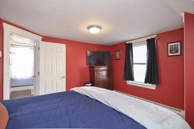 bedroom featuring multiple windows and baseboards