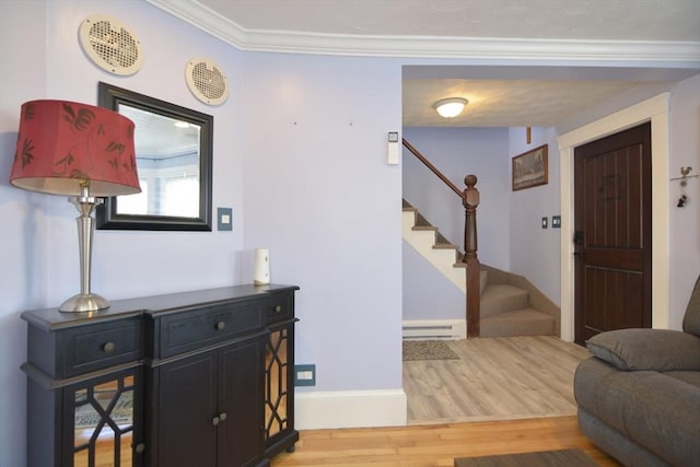 entryway featuring crown molding, a baseboard radiator, wood finished floors, baseboards, and stairs