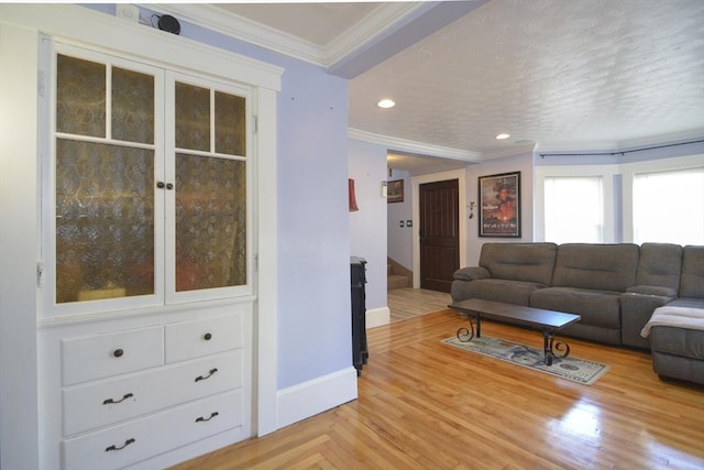 living area with recessed lighting, parquet flooring, baseboards, stairway, and crown molding