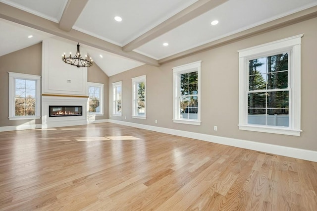 unfurnished living room with beamed ceiling, light wood-type flooring, a chandelier, and a healthy amount of sunlight