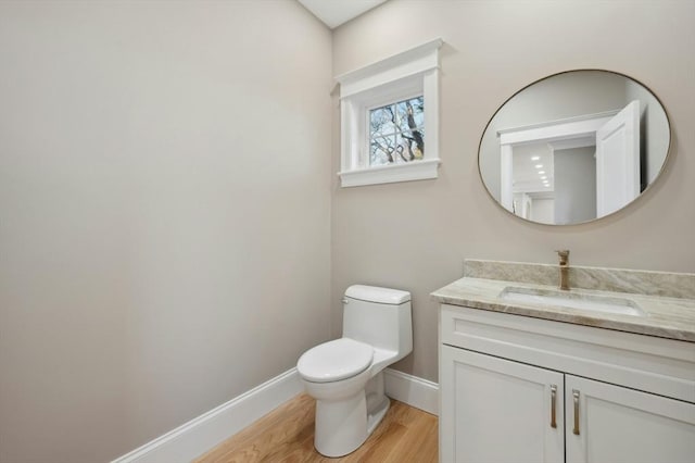 bathroom featuring hardwood / wood-style floors, vanity, and toilet