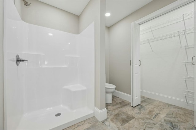 bathroom with a shower and toilet