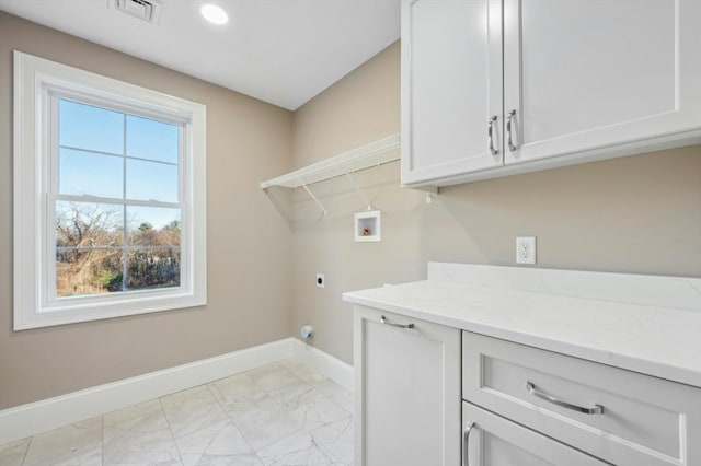 laundry area featuring hookup for an electric dryer, washer hookup, and cabinets