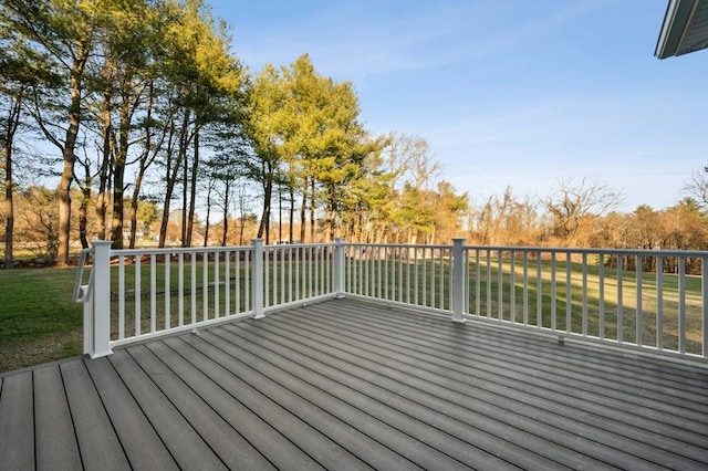 wooden terrace featuring a yard