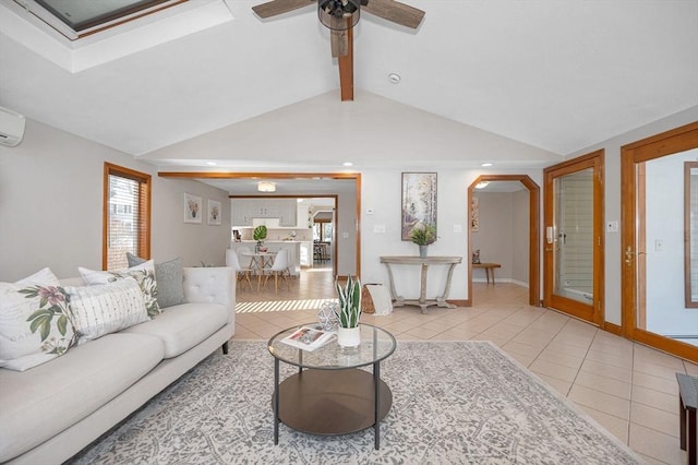 living room featuring lofted ceiling with beams, a wall mounted AC, light tile patterned floors, and ceiling fan