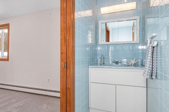 bathroom featuring vanity, tile walls, and a baseboard heating unit