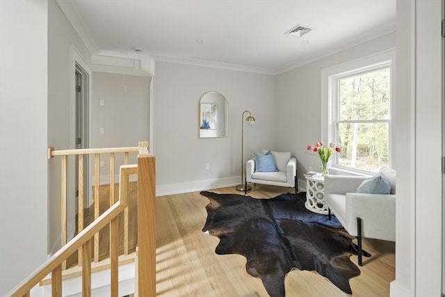 54 Stone Rd, Sudbury, MA 01776 - sitting room with attic access, wood finished floors, crown molding, baseboards, and an upstairs landing