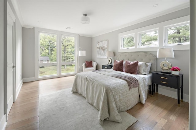 54 Stone Rd, Sudbury, MA 01776 - bedroom with crown molding, light wood-style floors, baseboards, and access to outside