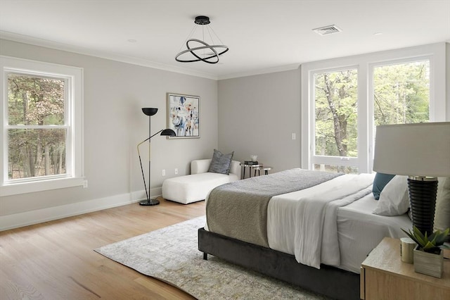54 Stone Rd, Sudbury, MA 01776 - bedroom with wood finished floors, multiple windows, baseboards, crown molding, and a chandelier