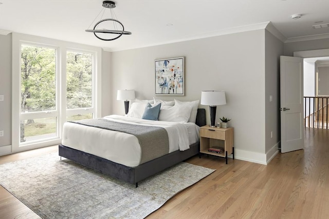54 Stone Rd, Sudbury, MA 01776 - bedroom featuring light wood-style floors, baseboards, and ornamental molding
