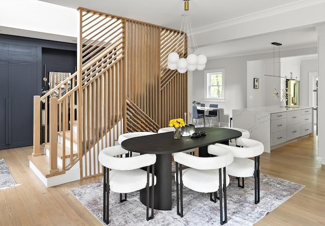 54 Stone Rd, Sudbury, MA 01776 - dining space featuring light wood-style floors, stairs, and ornamental molding