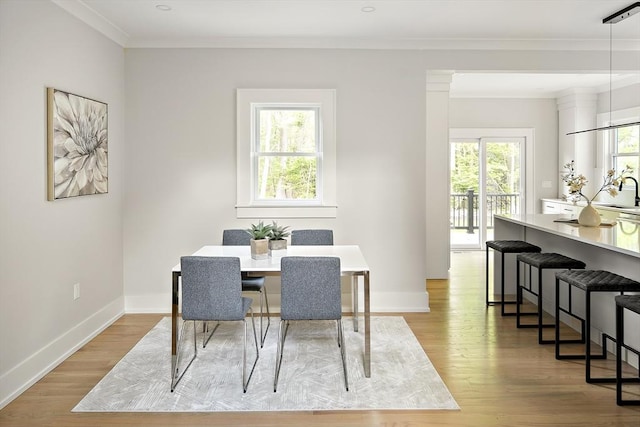 54 Stone Rd, Sudbury, MA 01776 - dining space featuring light wood-style floors, crown molding, and baseboards
