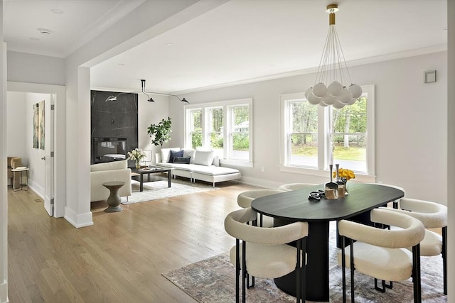 54 Stone Rd, Sudbury, MA 01776 - dining room featuring crown molding, light wood finished floors, and baseboards