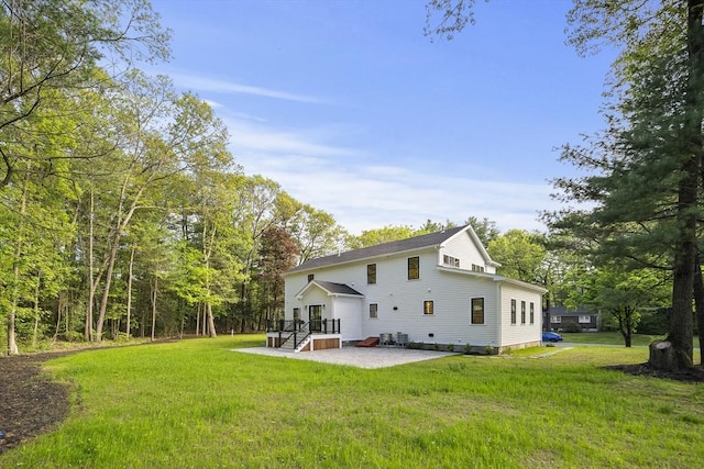54 Stone Rd, Sudbury, MA 01776 - back of property featuring a patio area and a yard