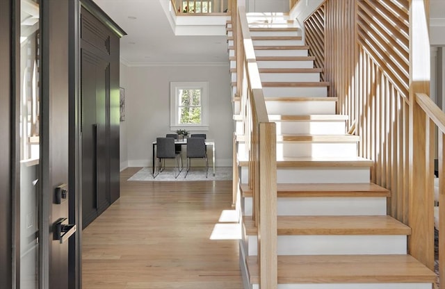 54 Stone Rd, Sudbury, MA 01776 - staircase featuring crown molding, wood finished floors, and baseboards