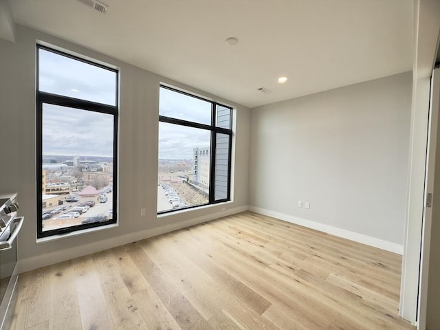 spare room featuring light hardwood / wood-style floors