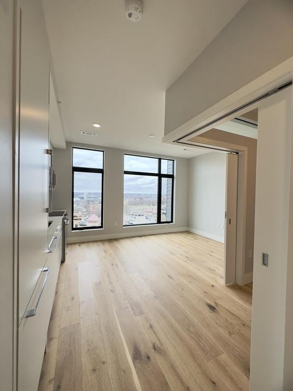 unfurnished room with light wood-type flooring