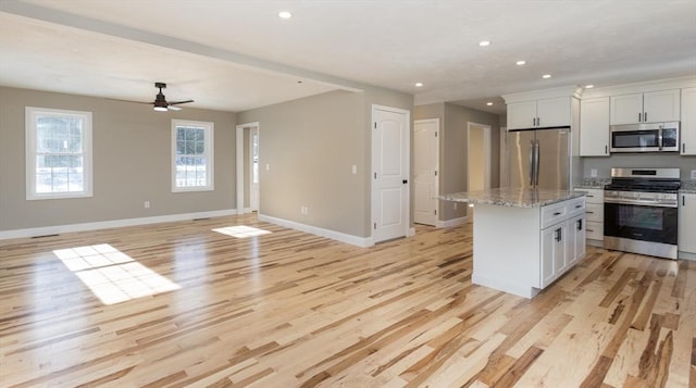261/2 Cherry St, Spencer, MA 01562 - kitchen with light wood-style flooring, a center island, appliances with stainless steel finishes, and baseboards