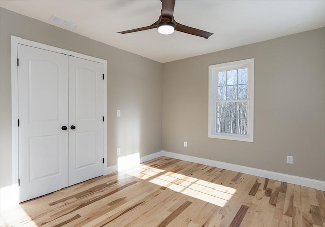 261/2 Cherry St, Spencer, MA 01562 - unfurnished bedroom featuring a ceiling fan, a closet, light wood-style floors, baseboards, and visible vents