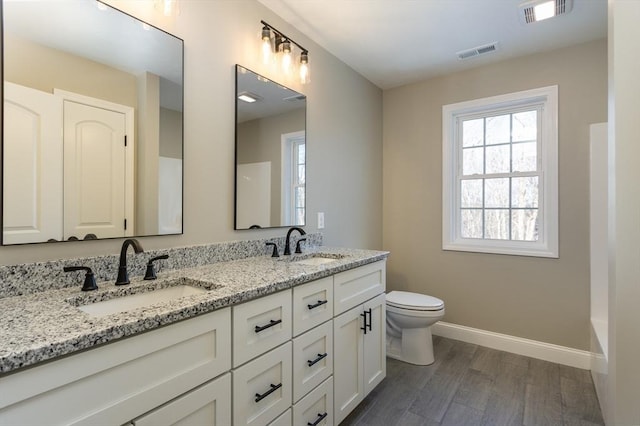 261/2 Cherry St, Spencer, MA 01562 - bathroom featuring a wealth of natural light, wood finished floors, a sink, and visible vents