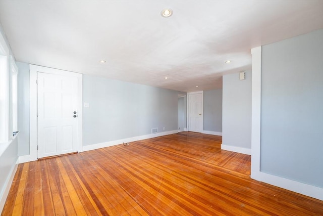 spare room with visible vents, recessed lighting, light wood-style flooring, and baseboards